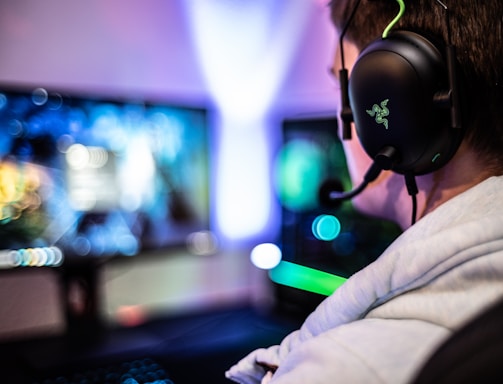 A friendly support agent wearing a headset, smiling and ready to assist gamers.
